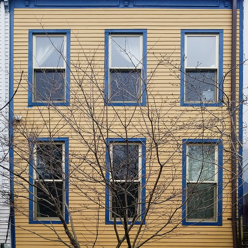 Home renovation featuring two-tone siding facade with bold color contrast